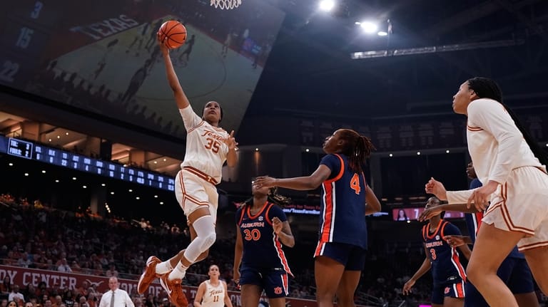 Texas forward Madison Booker (35)drives to the basket against Auburn...