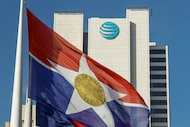 A City of Dallas flag flies in front of AT&T headquarters building Whitacre Tower in...
