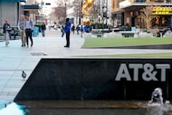 AT&T employees walk through the AT&T Discovery District outside their headquarters in...