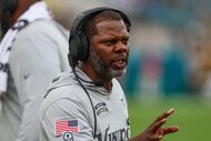 Minnesota Vikings passing game coordinator/defensive backs coach Daronte Jones speaks with a...