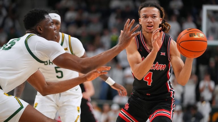 Houston guard Kingston Flemings (4) passes the ball while being...