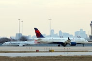 A Delta Airlines aircraft and an American Airlines aircraft wait to take off at DFW...