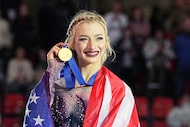 Amber Glenn, of the United States, poses after winning the gold medal in the women's event...