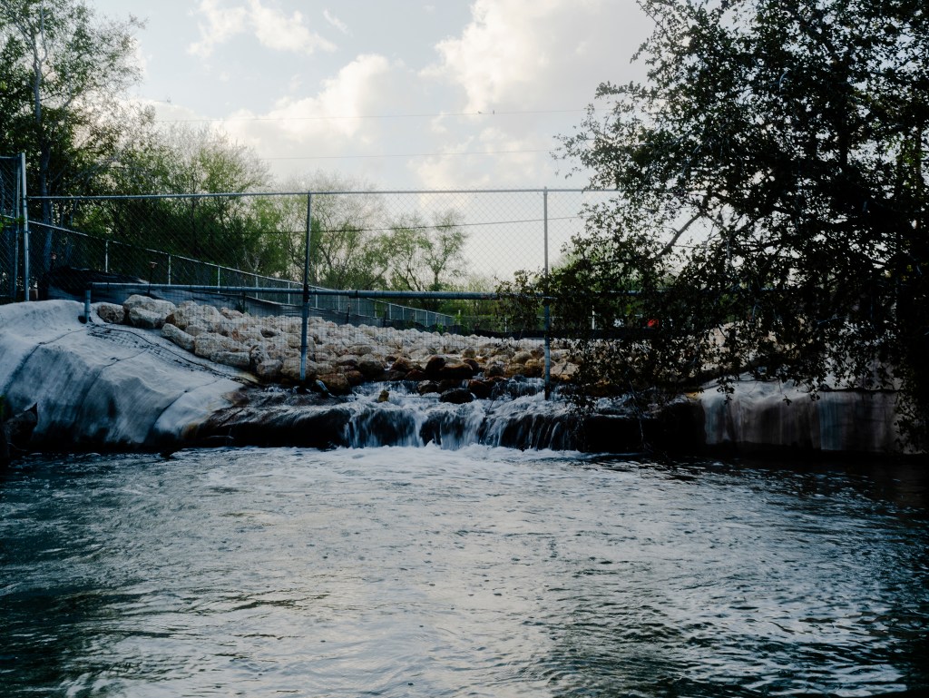 A cluster of six wells discharge water into the Nueces River.