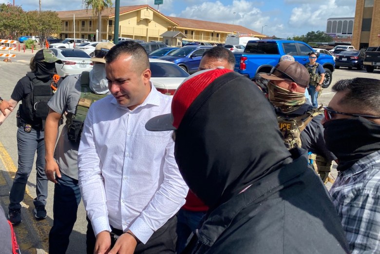 Masked immigration agents arrest a man last fall after he showed up for an asylum hearing in front of a judge. 