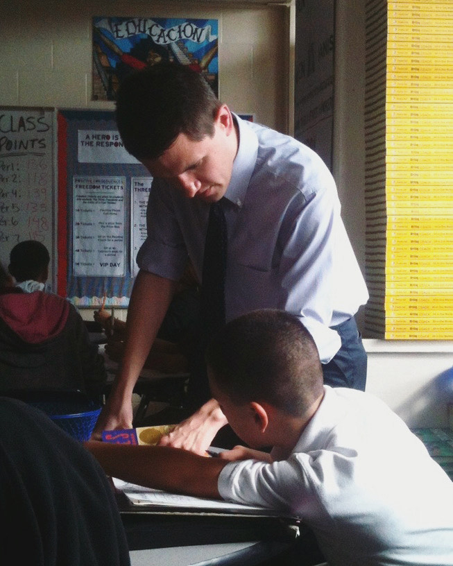 State Rep. and U.S. Senate candidate James Talarico speaks with a student at Jeremiah Rhodes Middle School, where he taught between 2011-13.