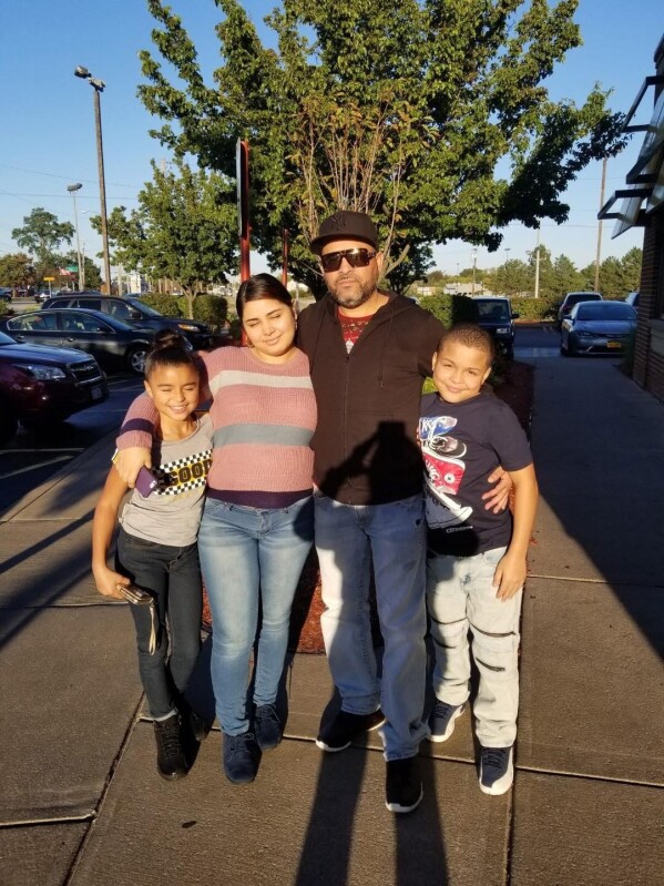 This undated photo provided by Jeanette Pagan-Lopez shows Geraldo Lunas Campos with his three children. Lunas Campos died Jan. 3, 2026, at an ICE detention facility in El Paso, Texas. (Jeanette Pagan-Lopez via AP)