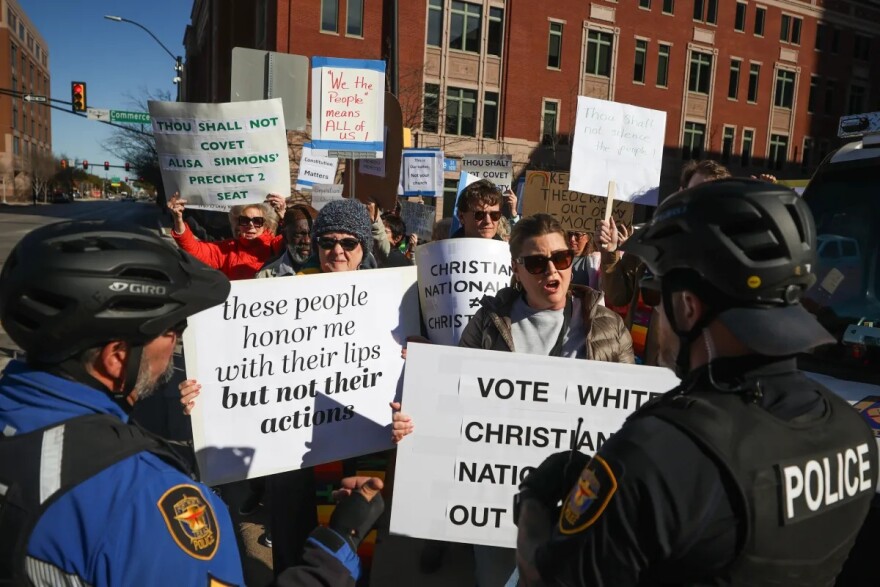 A group of protestors gather near the Tarrant County Courthouse during a dedication ceremony for a monument displaying the Ten Commandments on Jan. 16, 2026.