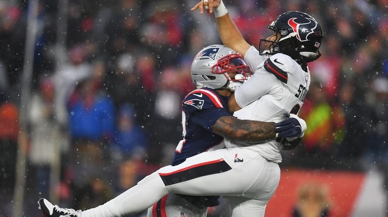 New England Patriots linebacker K'lavon Chaisson, left, hits Houston Texans...