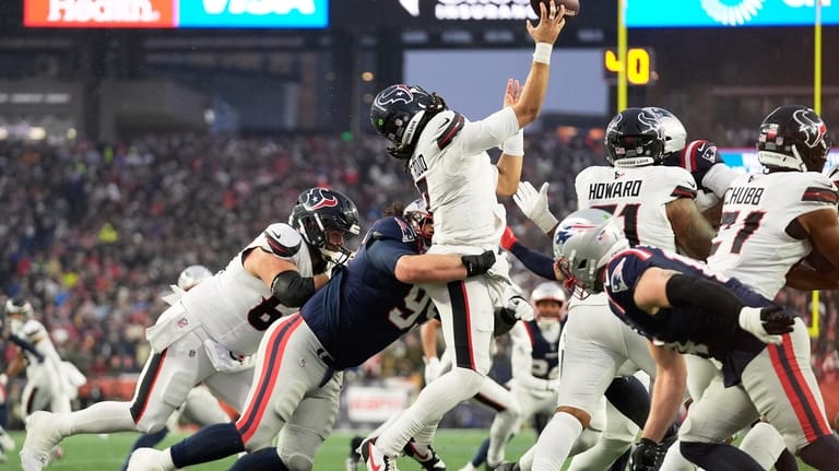 Houston Texans quarterback C.J. Stroud, middle, is hit by New...