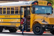 Students board a Garland ISD bus outside Garland High School on Friday, Oct. 22, 2021, in...