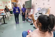 Saki Milton, Gems Camp founder and director, warms up students Malaisja Crayton, 9, front,...