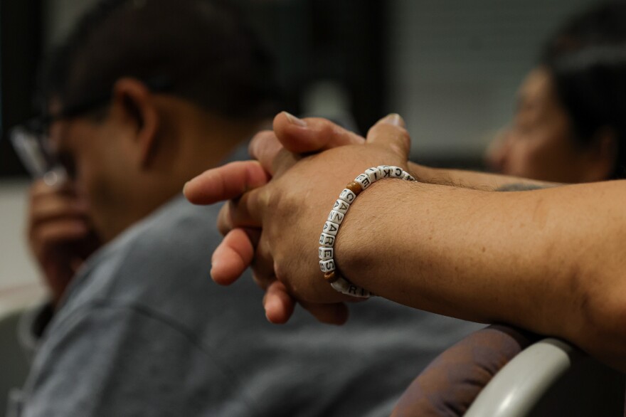 Javier Cazares, father of Robb Elementary shooting victim Jackie Cazares, wears a bracelet honoring her memory as he watches the trial with other parents whose children died in the shooting, including Jerry Mata, back, father of Tess Mata, during the trial of former Uvalde school district police officer Adrian Gonzales at the Nueces County Courthouse on Wednesday, Jan. 14, 2026, in Corpus Christi, Texas.