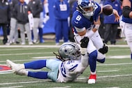New York Giants quarterback Jaxson Dart (6) fumbles the ball after being tackled by Dallas...