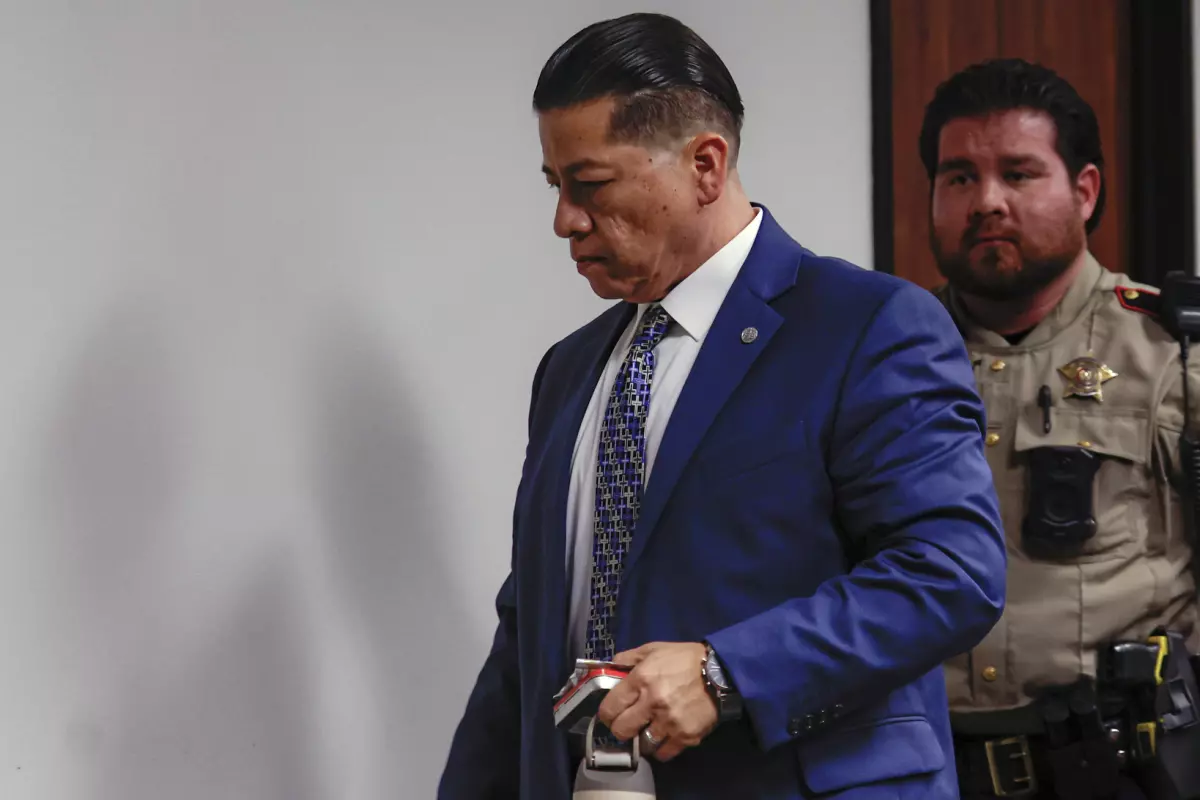 Former Uvalde school district police officer Adrian Gonzales leaves the courtroom as the jury goes back to deliberate during his trial at the Nueces County Courthouse on Wednesday, Jan. 21, 2026, in Corpus Christi, Texas.