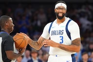 Dallas Mavericks center Anthony Davis touches the game ball before a preseason NBA...