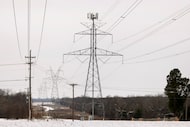 A file photo shows large electrical transmission lines cross through South Arlington, Texas,...