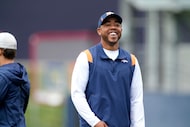 Denver Broncos defensive backs coach Christian Parker takes part in drills Tuesday, May 31,...