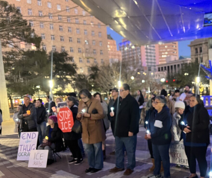 People held candles and signs at a vigil downtown at San Jacinto Plaza in memory of immigrants at a detention camp who died in custody. 