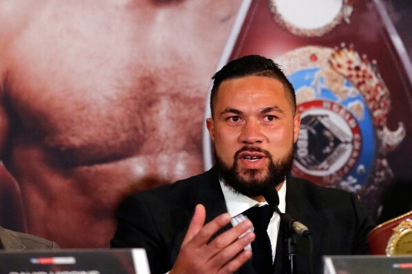 New Zealand's Joseph Parker speaks in front of his picture during a media conference with World Heavyweight boxer Anthony Joshua of Britain in London, Tuesday, Jan. 16, 2018. (AP Photo/Frank Augstein, File)