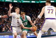 Dallas Mavericks forward Cooper Flagg (32) tries to drive past Los Angeles Lakers forward...