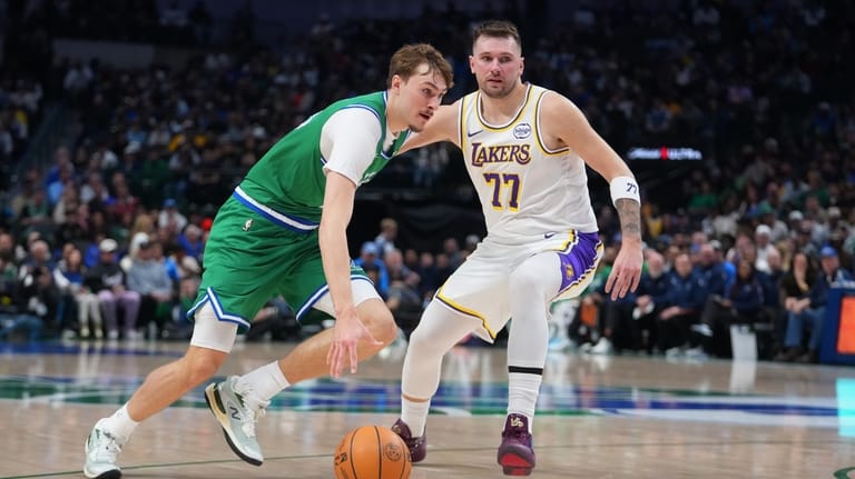 Dallas Mavericks forward Cooper Flagg, left, drives past Los Angeles...