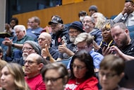Audience members clap as Dallas City Council members question the regional library model...