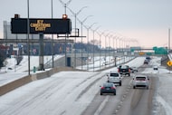 Motorists travel along a snow and ice covered I-35W on Friday, Feb. 4, 2022 in Fort Worth....