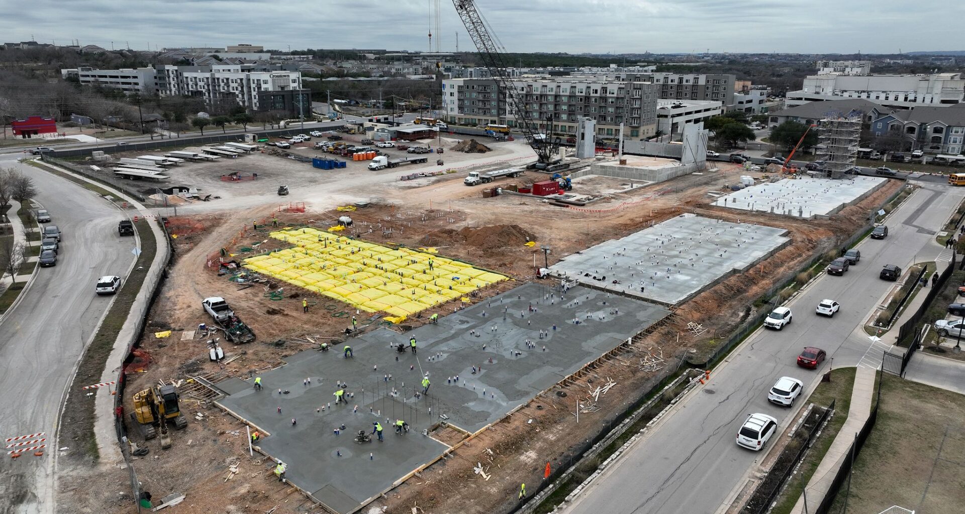 Bri Houk watches as her children Jefferson Day, 6, pushes Atlas Day, 9, in a laundry basket as they attempt to sled at Zilker Park following a winter storm in Austin Monday, Jan. 26, 2026.