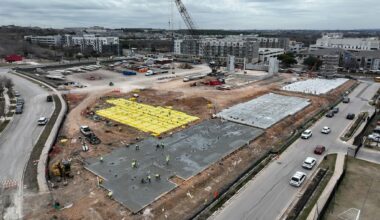 Bri Houk watches as her children Jefferson Day, 6, pushes Atlas Day, 9, in a laundry basket as they attempt to sled at Zilker Park following a winter storm in Austin Monday, Jan. 26, 2026.