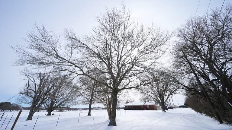 Ice and snow cover the exterior of a residence near...