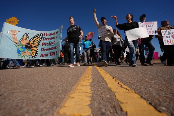 Protesters march to the South Texas Family Residential Center detention facility where Liam Ramos and his father are being detained in Dilley, Texas, Wednesday, Jan. 28, 2026. (AP Photo/Eric Gay)