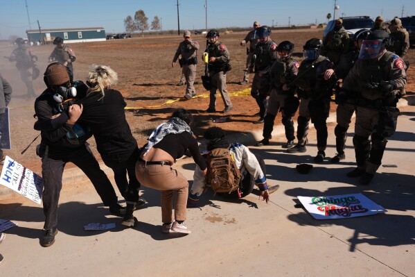EDS NOTE: OBSCENITY - Texas state troopers advance on protesters, launching pepper spray outside the South Texas Family Residential Center detention facility where Liam Ramos and his father are being detained in Dilley, Texas, Wednesday, Jan. 28, 2026. (AP Photo/Eric Gay)