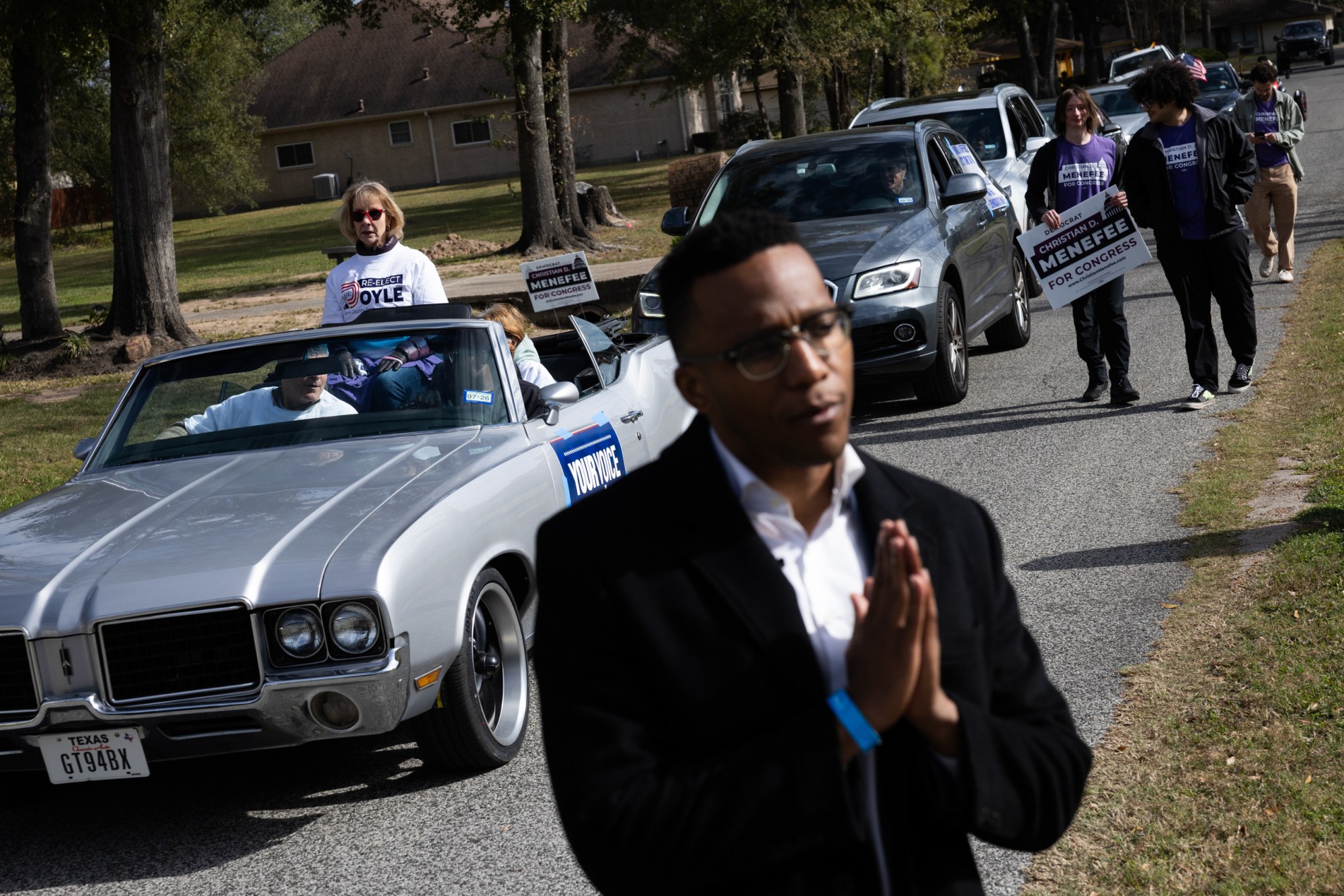 Christian Menefee, candidate for Texas’s 18th Congressional District, speaks with a resident while trailed by a caravan of campaign supporters on Jan. 17, 2026, in Houston.