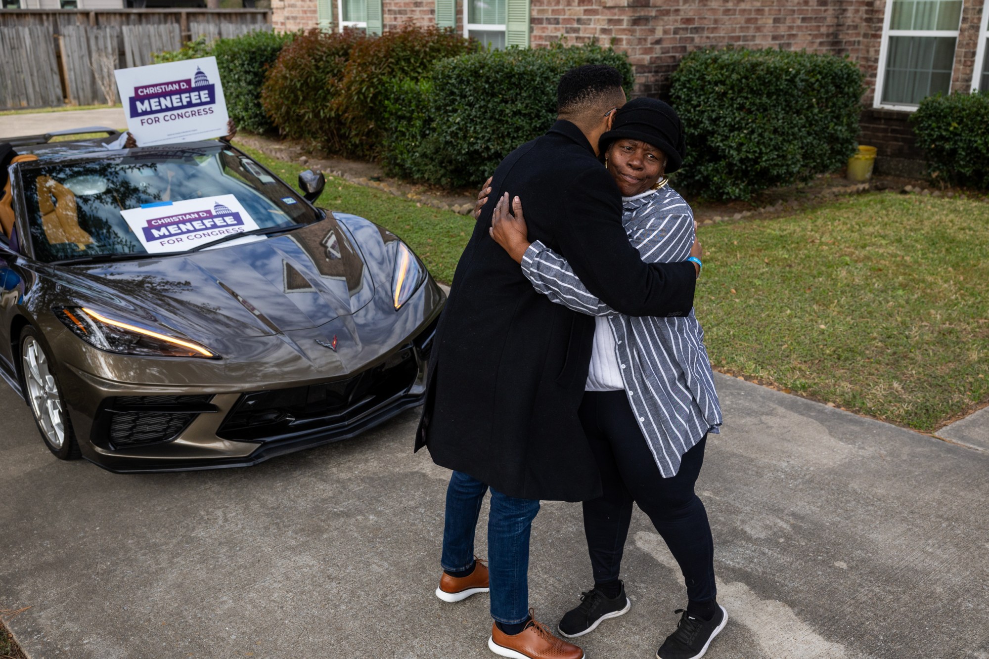 Christian Menefee, congressional candidate for Texas’s 18th district, hugs Stephanie Morales during a caravan campaign event to encourage people to vote, Saturday, Jan. 17, 2026, in Houston.