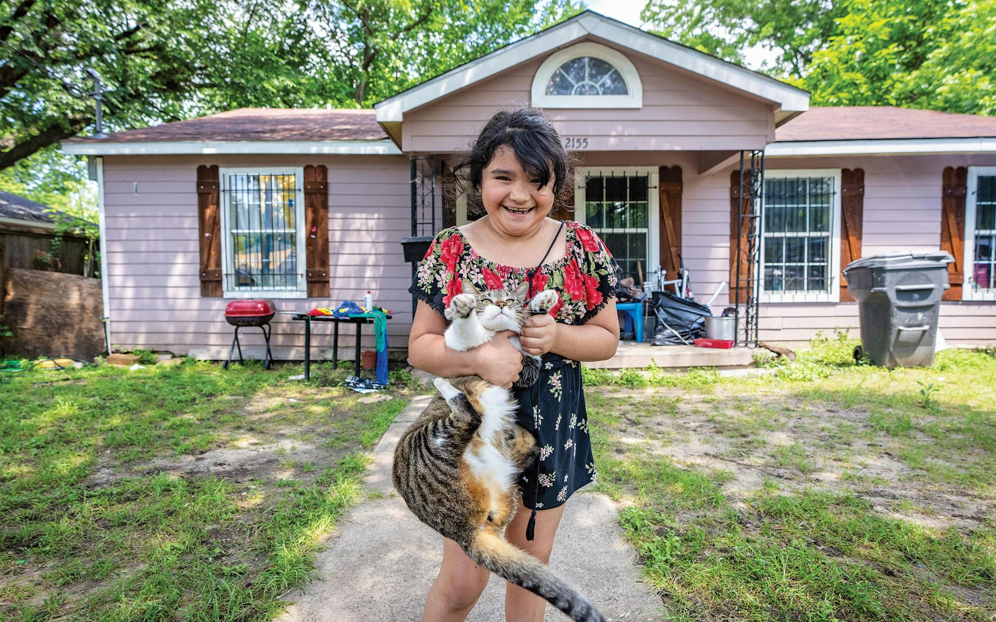 May 10 NOON Seven-year-old Melina Moreno cuddling her alarmed cat in front of her home in the heart of South Dallas.