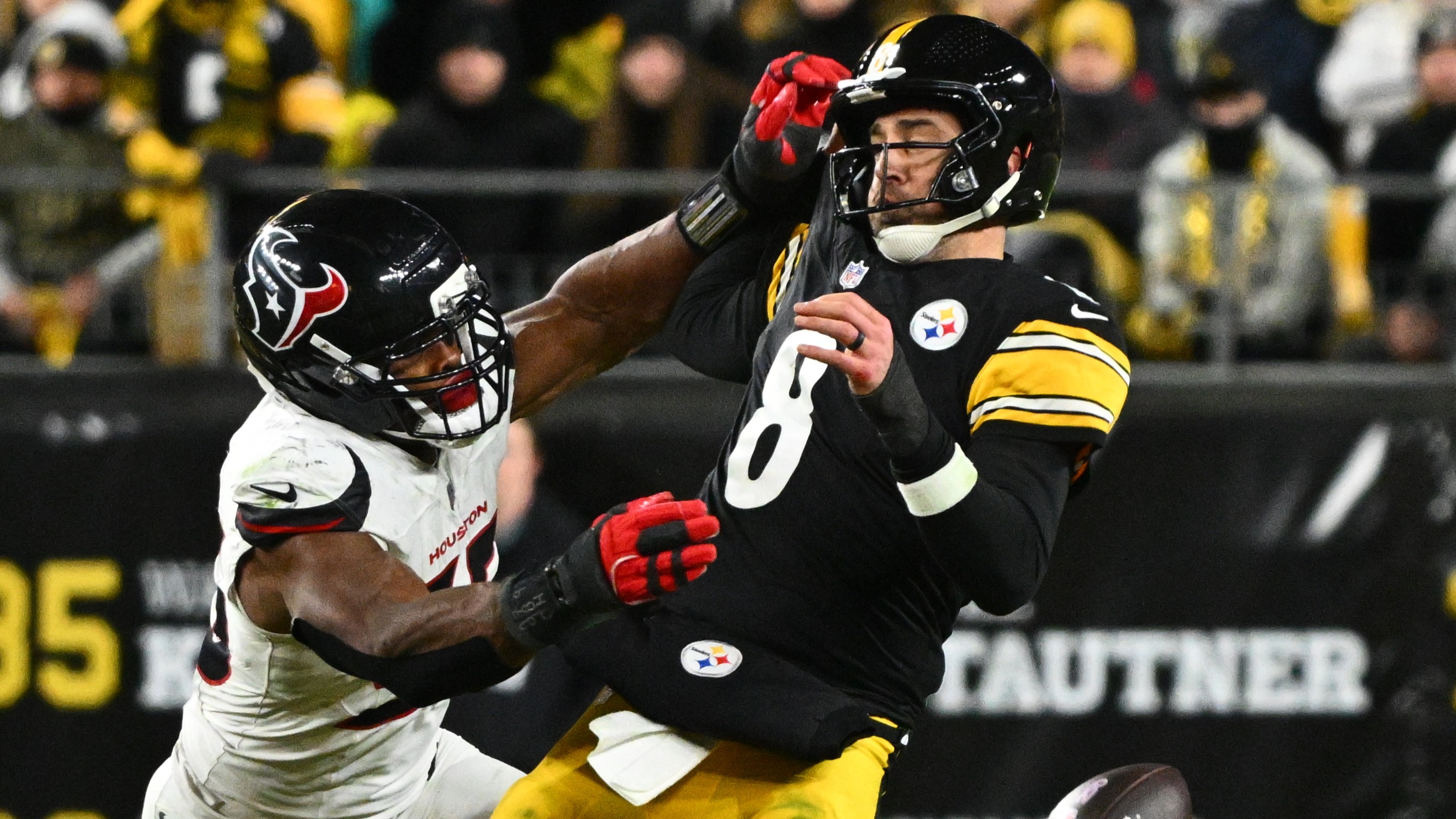 Steelers quarterback Aaron Rodgers (8) loses possession of the ball while being tackled by Texans defensive end Danielle Hunter (55) on Monday, Jan. 12, 2026, in Pittsburgh.