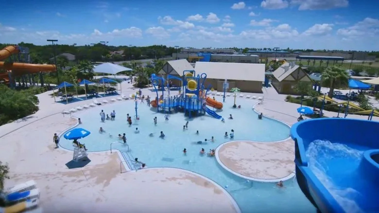 group of children playing in pool with playground equipment at Pharr's Aquatic Center