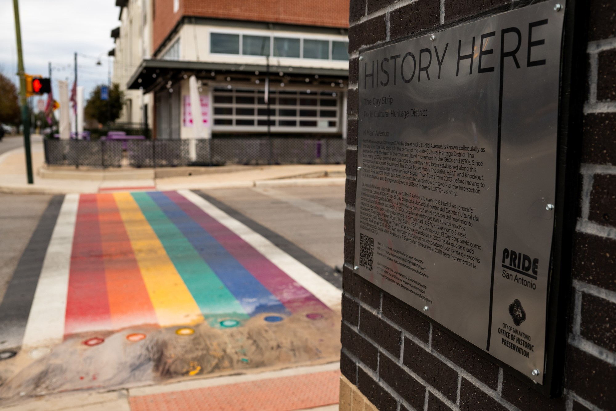 A plaque commemorating San Antonio's Pride Cultural Heritage District and the rainbow crosswalk, which construction workers begin removing on Jan. 12, 2026 in San Antonio.