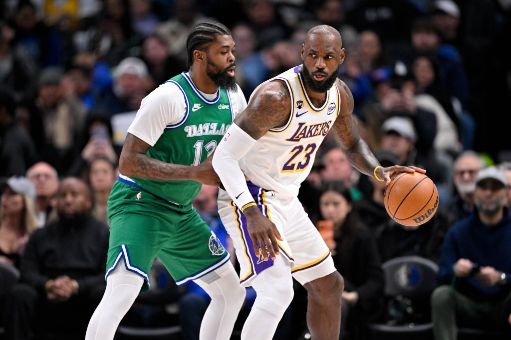 LeBron James with the ball, being guarded by Naji Marshall.