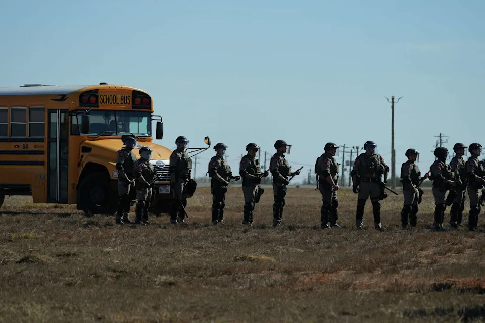 Texas state troopers wearing riot gear arrive to help disperse protesters gathered outside the South Texas Family Residential Center detention facility where Liam Ramos and his father are being detained in Dilley, Texas, Wednesday, Jan. 28, 2026. (AP Photo/Eric Gay) (Eric Gay/AP)
