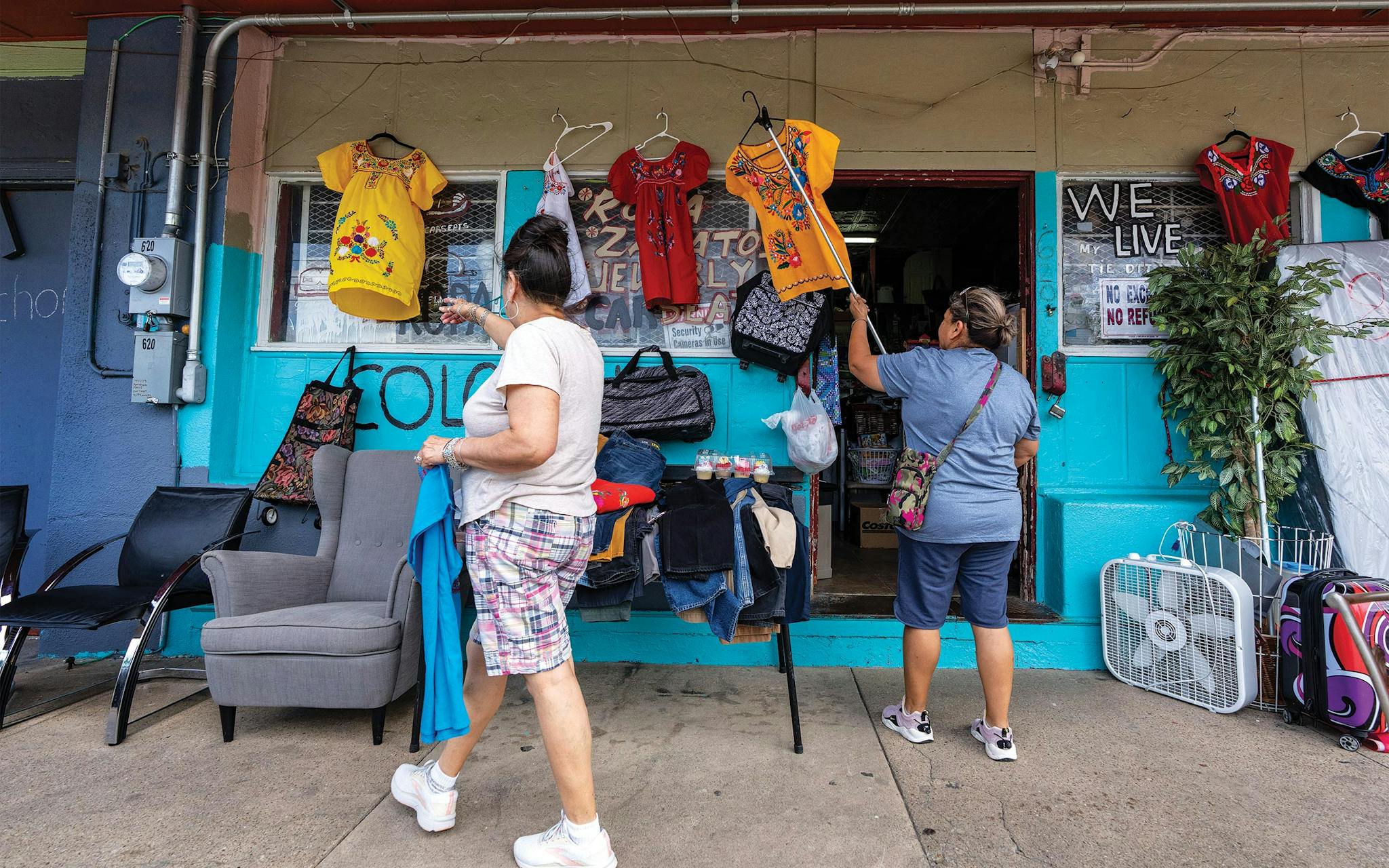 May 10 3:16 P.M. Elvia Rodriguez and her friend perusing dresses at a tiendita on East Tenth Street, just east of Marsalis Avenue.