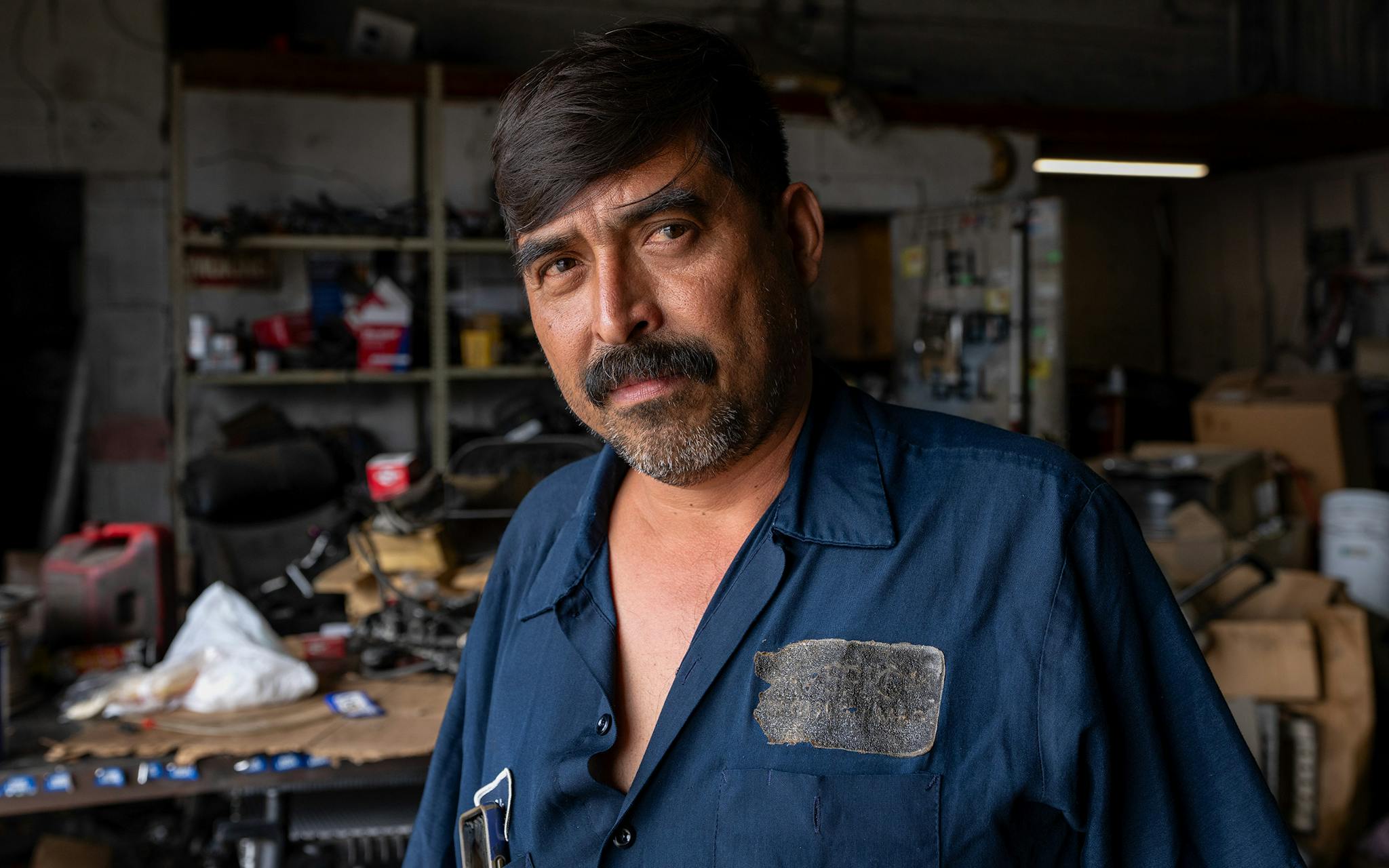 May 10 3:37 P.M. Ernesto Flores, 45, poses for a portrait in the auto mechanic shop he owns at Marsalis Avenue and 9th Street in Dallas. Flores, who is originally from Mexico and now lives in Irving, has worked at the shop for 24 years and run it for over 16. “Lots of people come in here, like, you know, white boys, black boys, Mexican,” Flores said, “but the most is Mexican...Right here in Oak Cliff, most people is Hispanic, speak my language, you know, the food, you know, you find the taste for Mexican food is better right here in this area.”