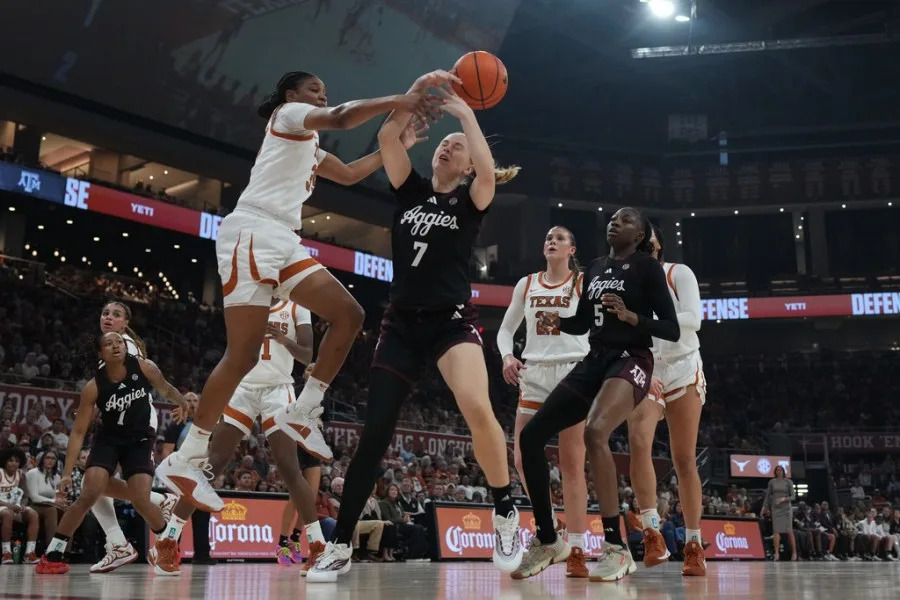 Texas A&M forward Pien Steenbergen (7) is blocked by Texas forward Madison Booker (35) during the first half of an NCAA college basketball game in Austin, Texas, Sunday, Jan. 18, 2026. (AP Photo/Eric Gay)