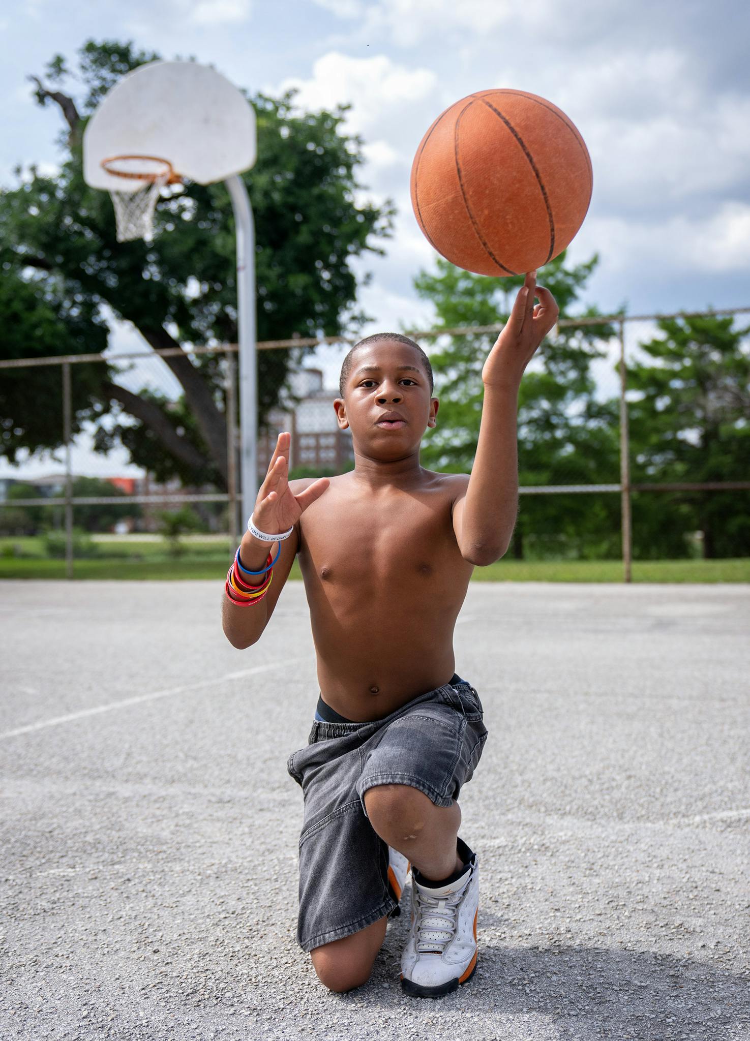 May 10 4:25 P.M. Kameron Sotire, 12, poses for a portrait on the basketball court at Lake Cliff Park. Kameron said he started out a football fan but switched to basketball after an injury. “You’re not a failure until you stop what you’re doing,” he said. “At first, I was like bad, where I couldn’t even shoot the ball and make it; now I can actually shoot where I can make it from a 3-pointer.” He also said he was proud of the progress he has made in math class, earning grades in the 100s.