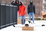 UT Dallas student Santosh Sahoo slides down a campus sidewalk covered in a wintery mix...