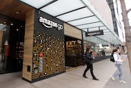 FILE - People walk out of an Amazon Go store in Seattle, March 4, 2020. (AP Photo/Ted S....