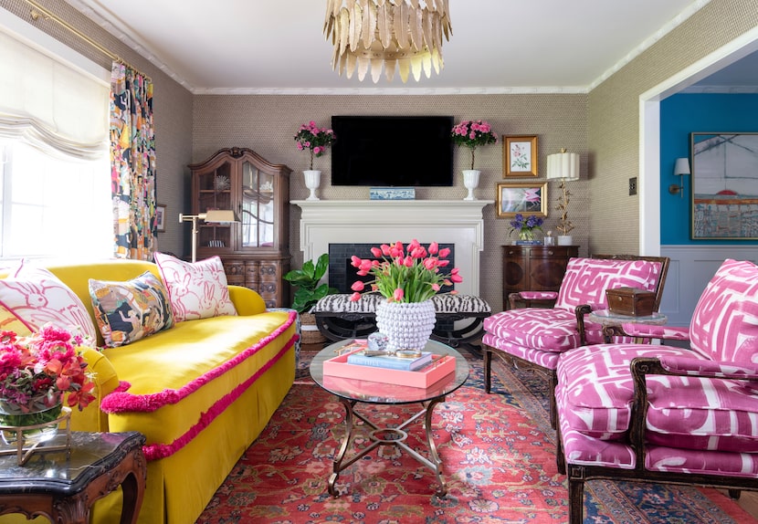 Colorful living room with yellow couch and pink armchairs