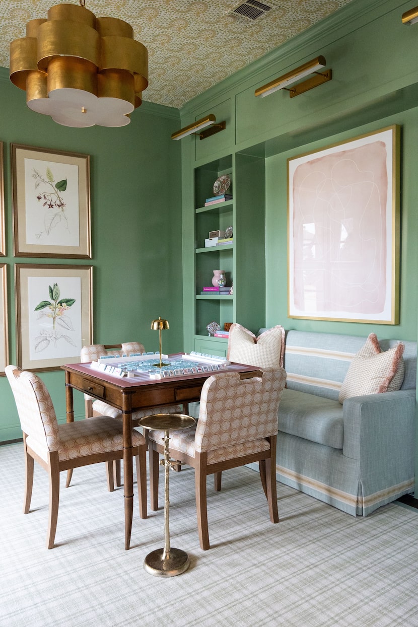 This mahjong room designed by Sarah Kuhlman plays double duty as an office workspace, as...