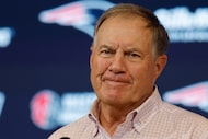 FILE - Then-New England Patriots head coach Bill Belichick talks with reporters following an...